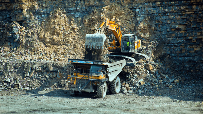 Heavy Machinery Being Used To Excavate Rock Thumbnail